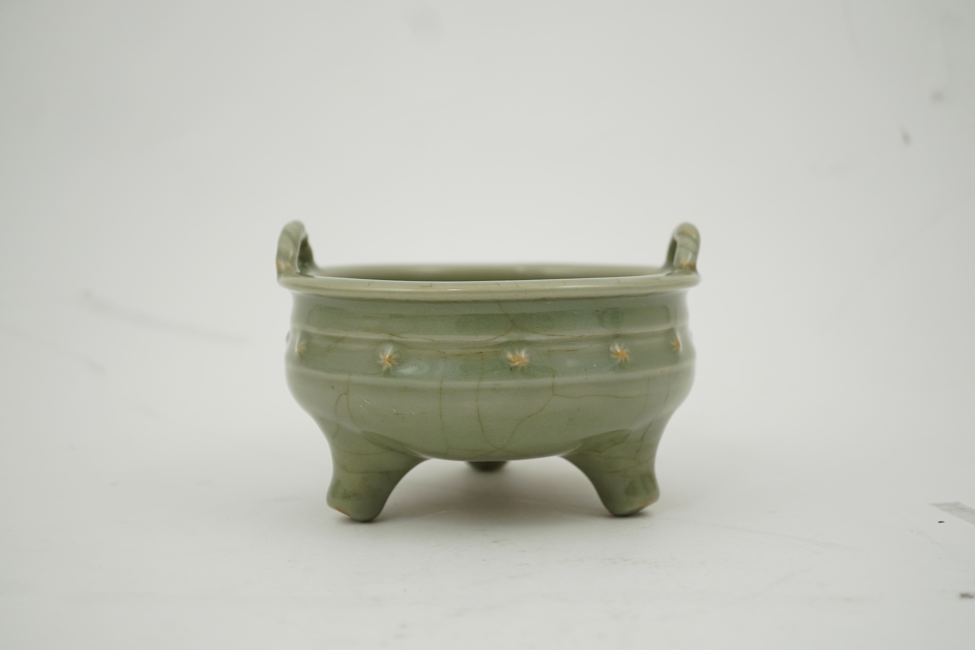 A Chinese Longquan celadon crackle glazed tripod censer, Ming dynasty or later